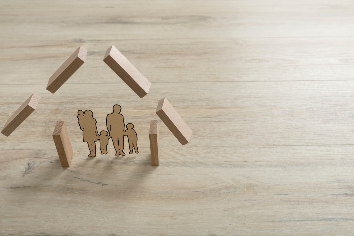 Real Estate Concept with a Cut Out of a Family inside the Shape